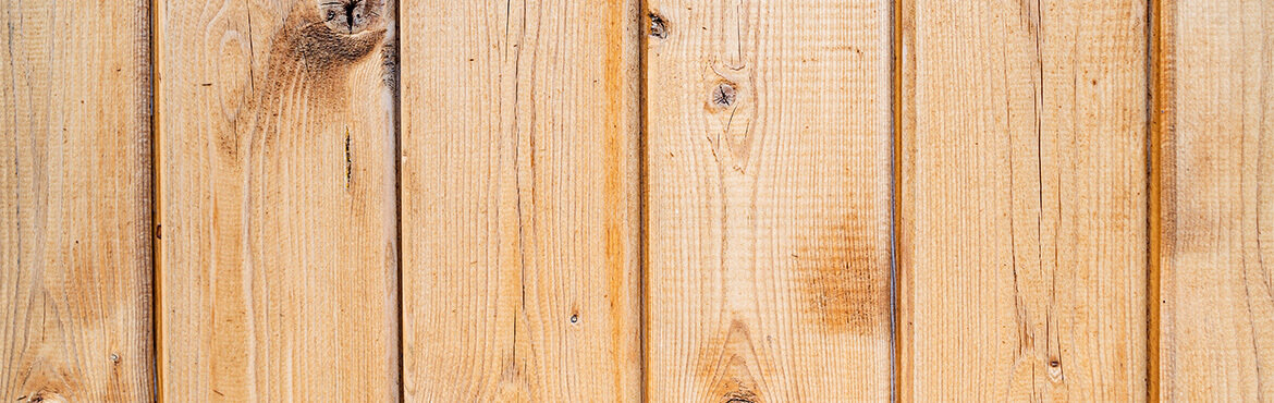 Lightly stained wood fencing in good condition, close up.